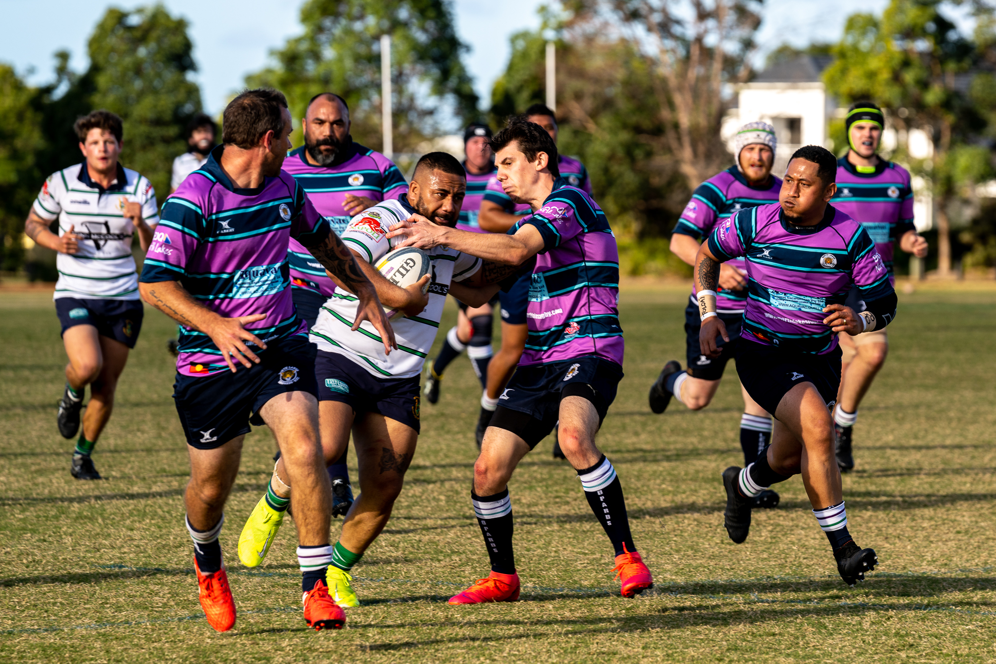 Rugby players running with the ball during a local match