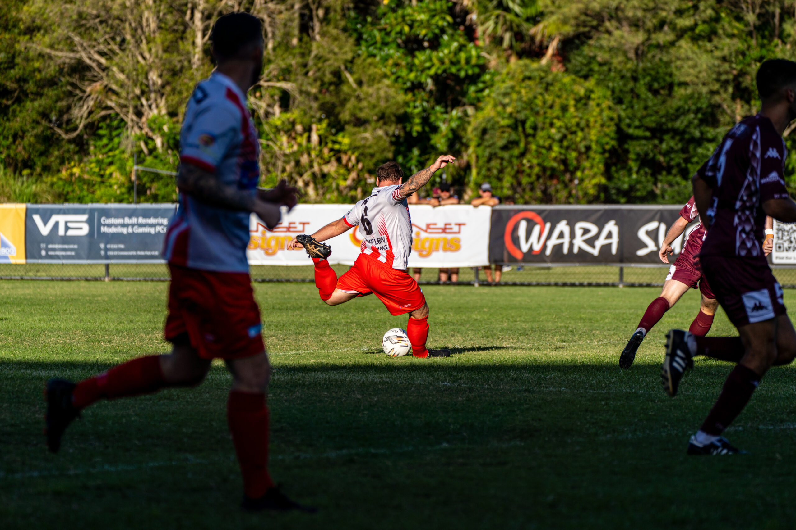 Footballer taking a shot during a local match