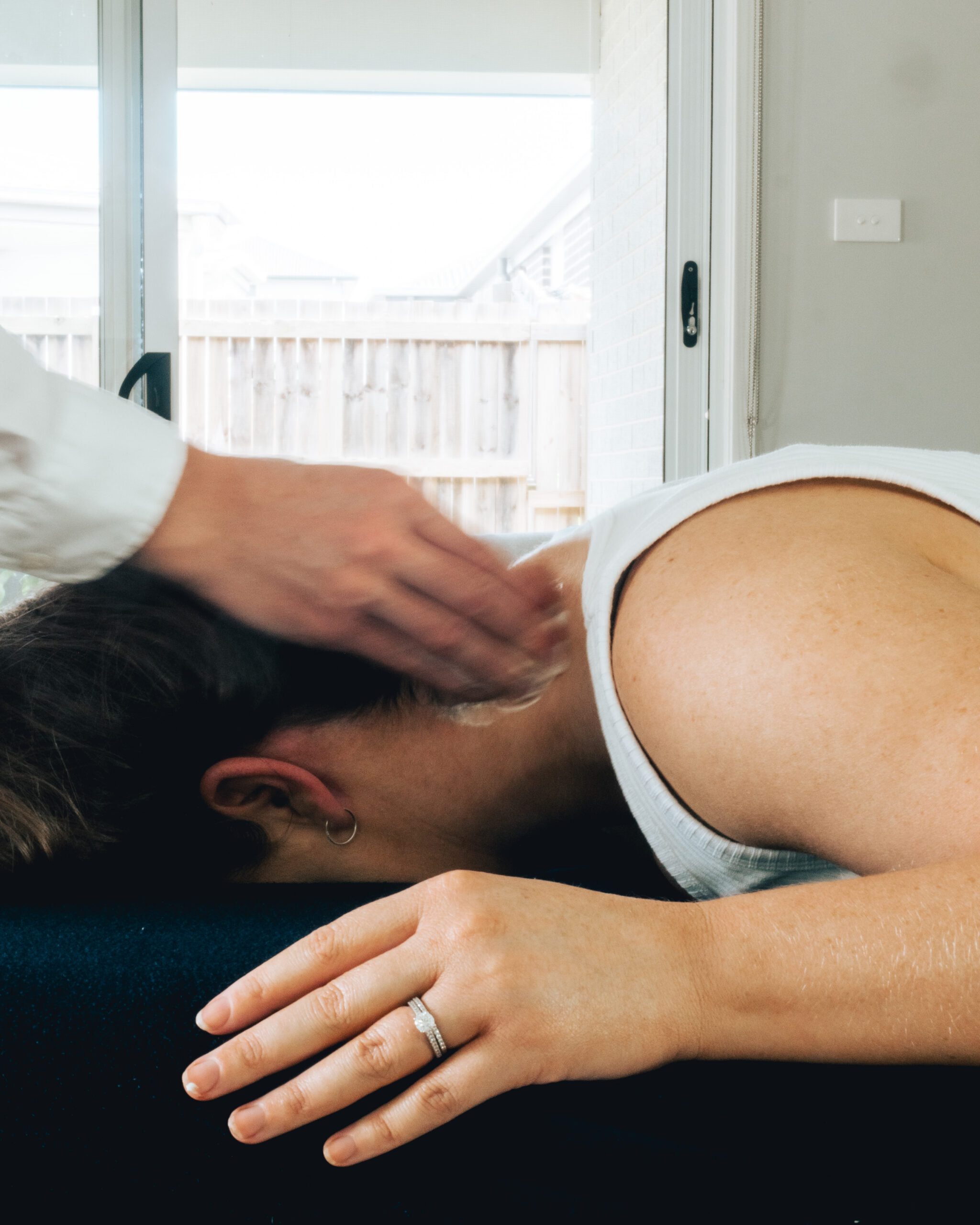 A woman receiving sports physiotherapy on her back.