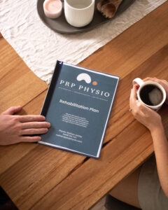 PRP Physio rehabilitation plan on a table during a home visit